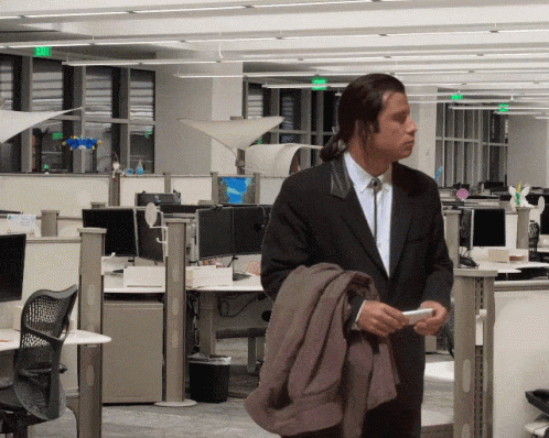 GIF of a confused John Travolta in an office